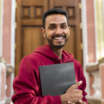 front view smiley man holding book